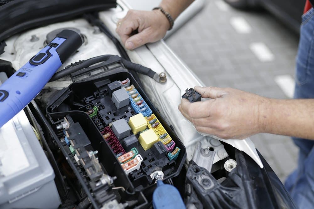 Mechanic working in a vehicle engine bay