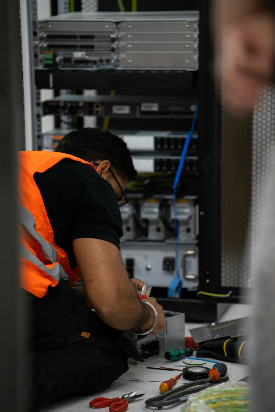 Technician working on a UPS rack