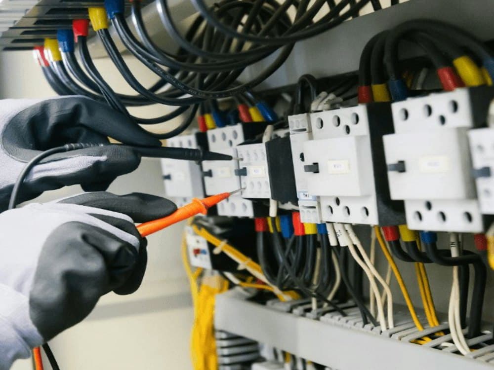 Electrician testing a distribution panel