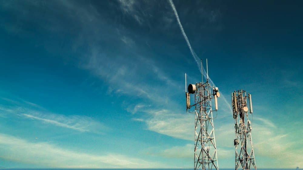 Telecom towers against a blue sky